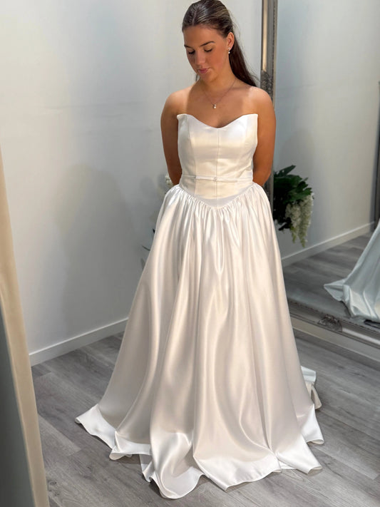 Front of Billie debutante dress, model looking toward the ground