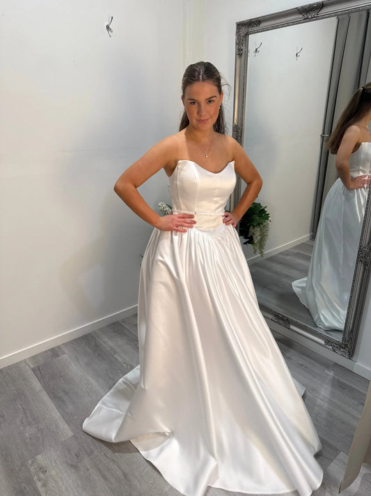 Side view of Billie debutante dress, model looking toward the camera