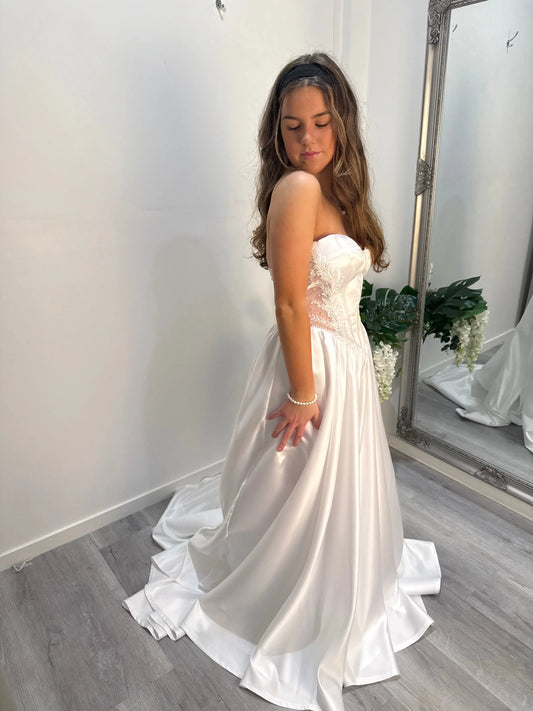 Side of the dress, model looking down showcasing detail