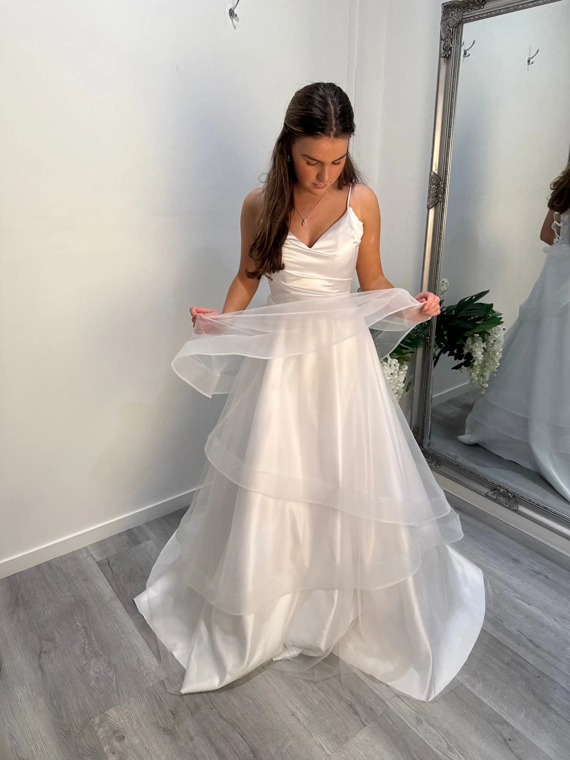 Model looking down, exposing the delicate layers of the soft tulle skirt