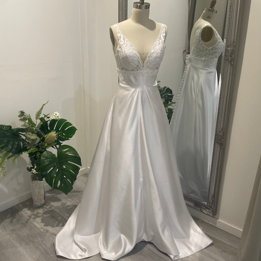 Aria Grace deb dress with lace V-neckline, defined waistband, and flowing A-line skirt