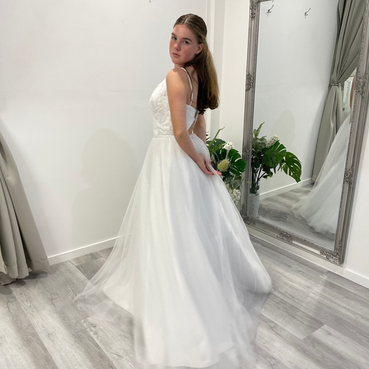 Side back view of Valentina Lace Essence Deb Dress highlighting the detailed lace corset bodice, with a flowing skirt that creates a soft and elegant movement.