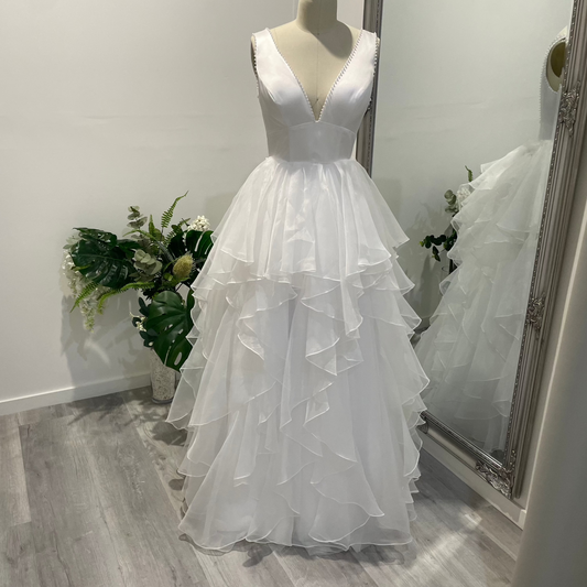 Liora Satin Whisper Deb Dress with pearl-trimmed V-neckline, satin A-line skirt, and slim straps