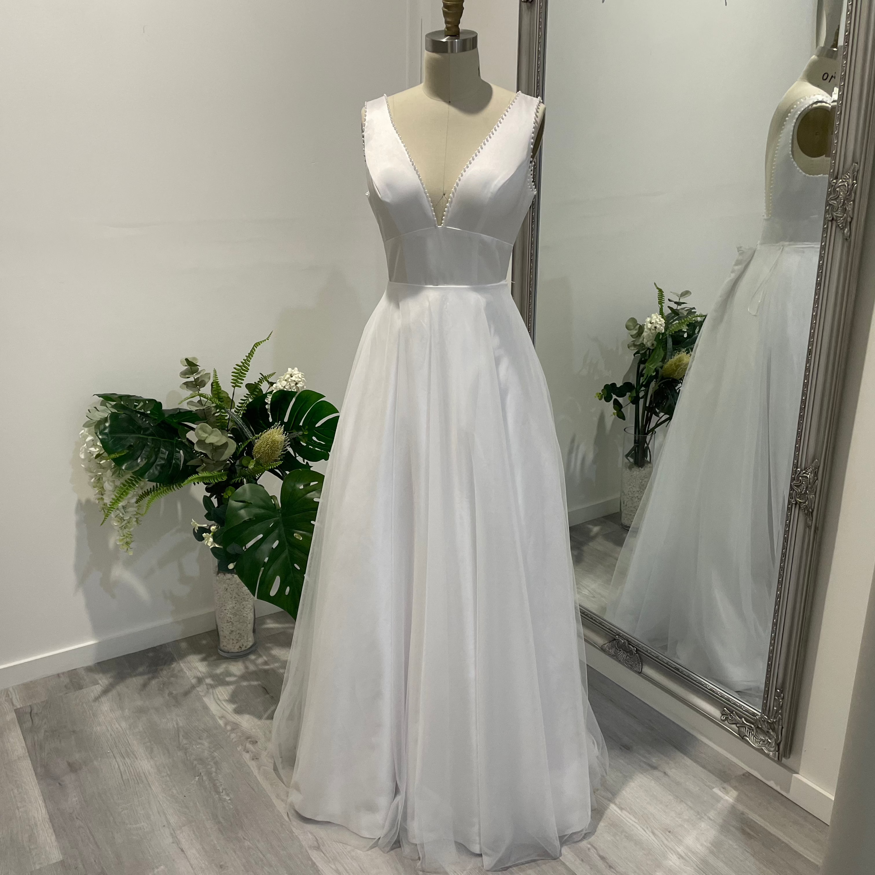 Liora Satin Whisper Deb Dress with pearl-trimmed V-neckline, satin A-line skirt, and slim straps