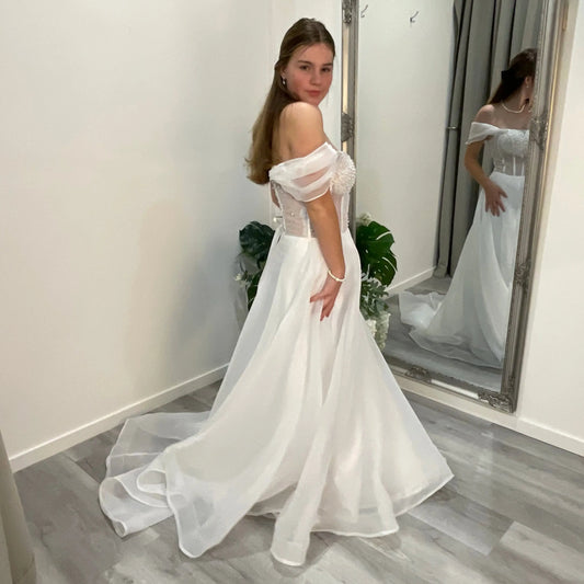 Diana Debutante Dress with a sweetheart neckline and beaded corset bodice, supported by straps and complemented by a flowing organza A-line skirt, creating a stunning, feminine silhouette.