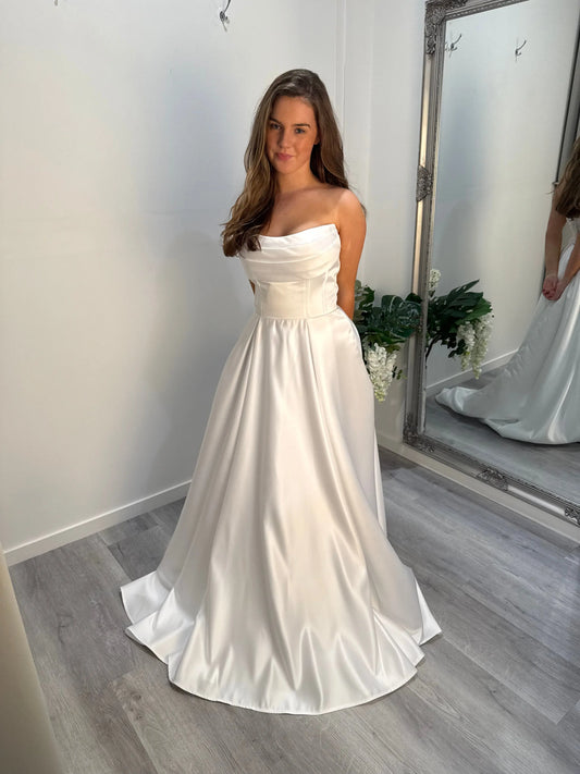 Front view of the Eden Debutante Dress highlighting strapless satin bodice and full skirt