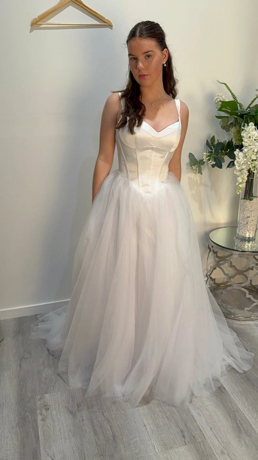 Girl showing the front of the Ivy debutante dress.
