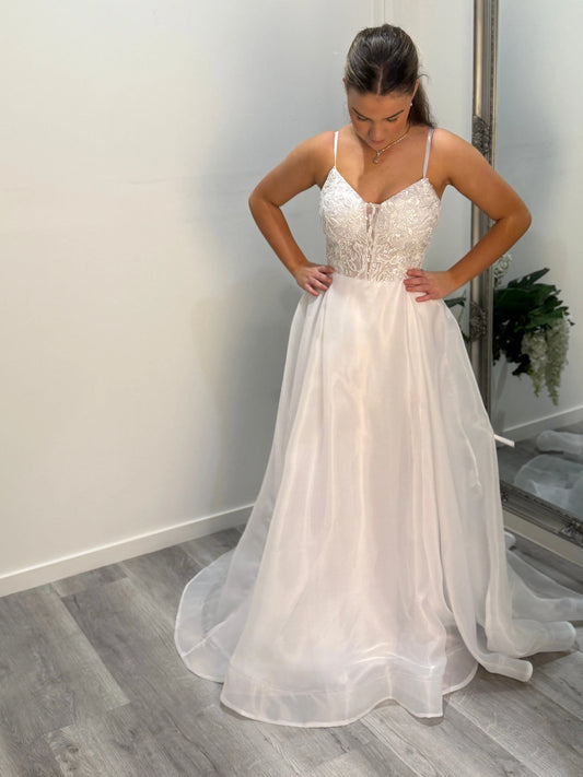 Front view of Marilyn debut dress, model gazing downward