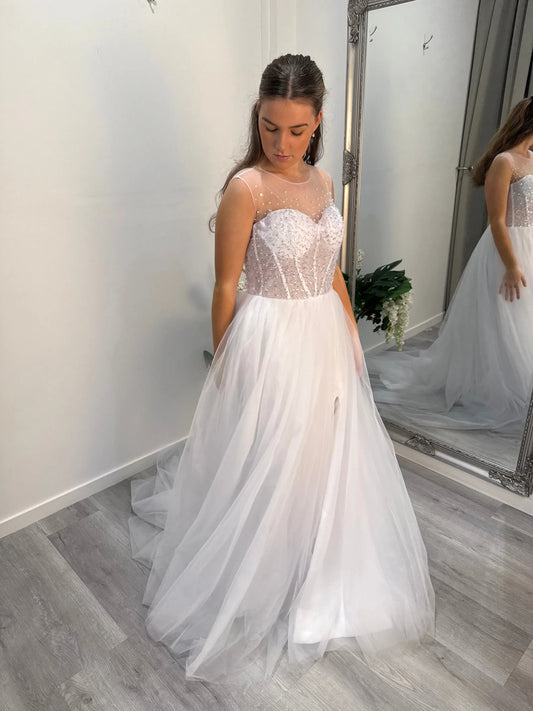 Side view of the Maxine dress showing sheer bodice and flowing skirt