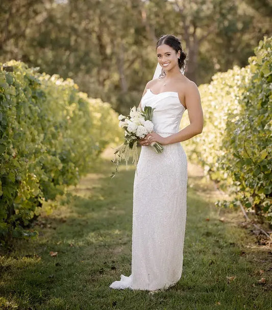 Front view of the Nina luxury wedding gown without satin skirt, revealing the sculpted strapless bodice and elegant beaded lace detailing for a modern bridal look.