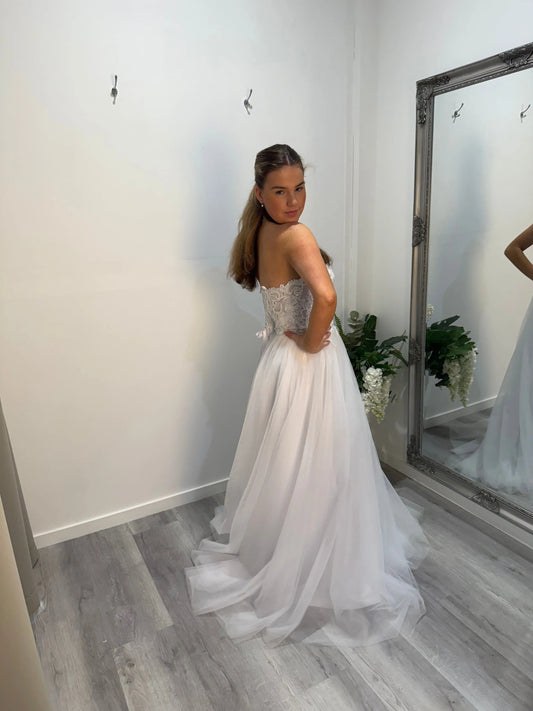 Side of Regina debut dress, model turned and glancing over her shoulder