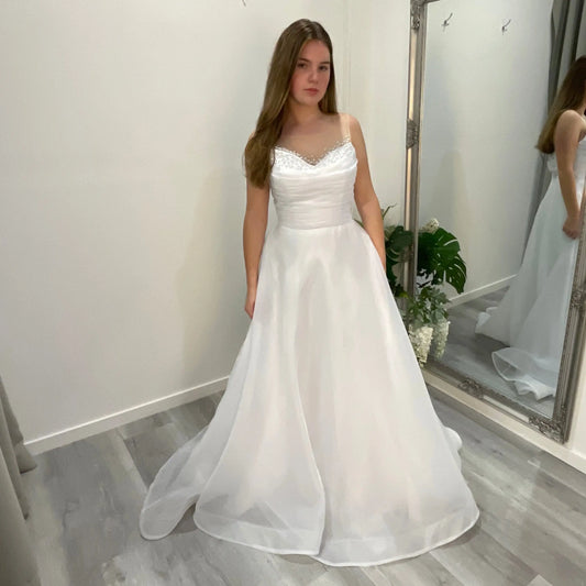 Starlit Debutante Dress with a sculpted sweetheart neckline embellished with Ilosian pearls, paired with organza draping that cascades elegantly into a full A-line organza skirt.