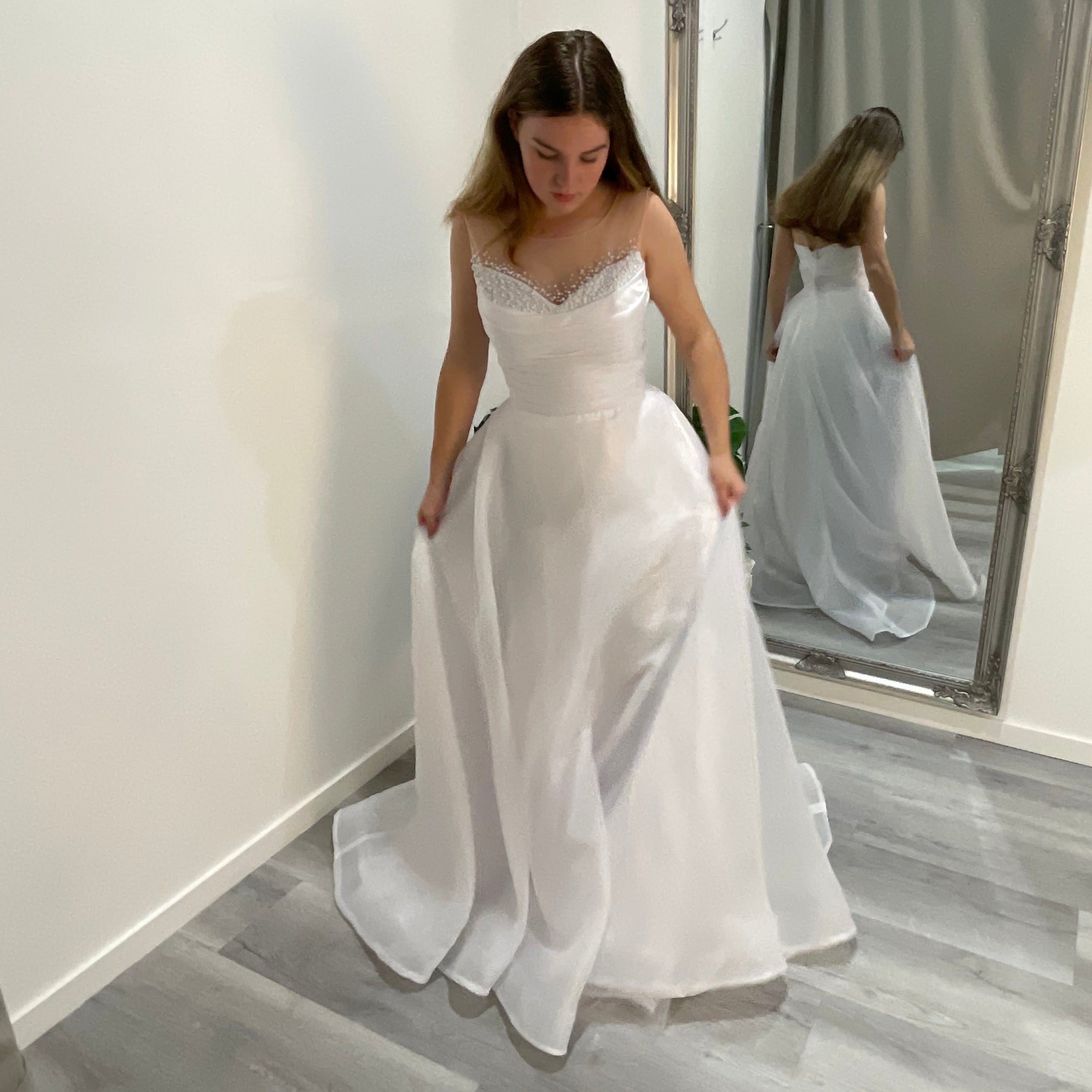 Close-up of Starlit Debutante Dress front, highlighting the intricate Ilosian pearl embellishments on the sweetheart neckline, flowing into an organza A-line skirt with a soft, ethereal finish.