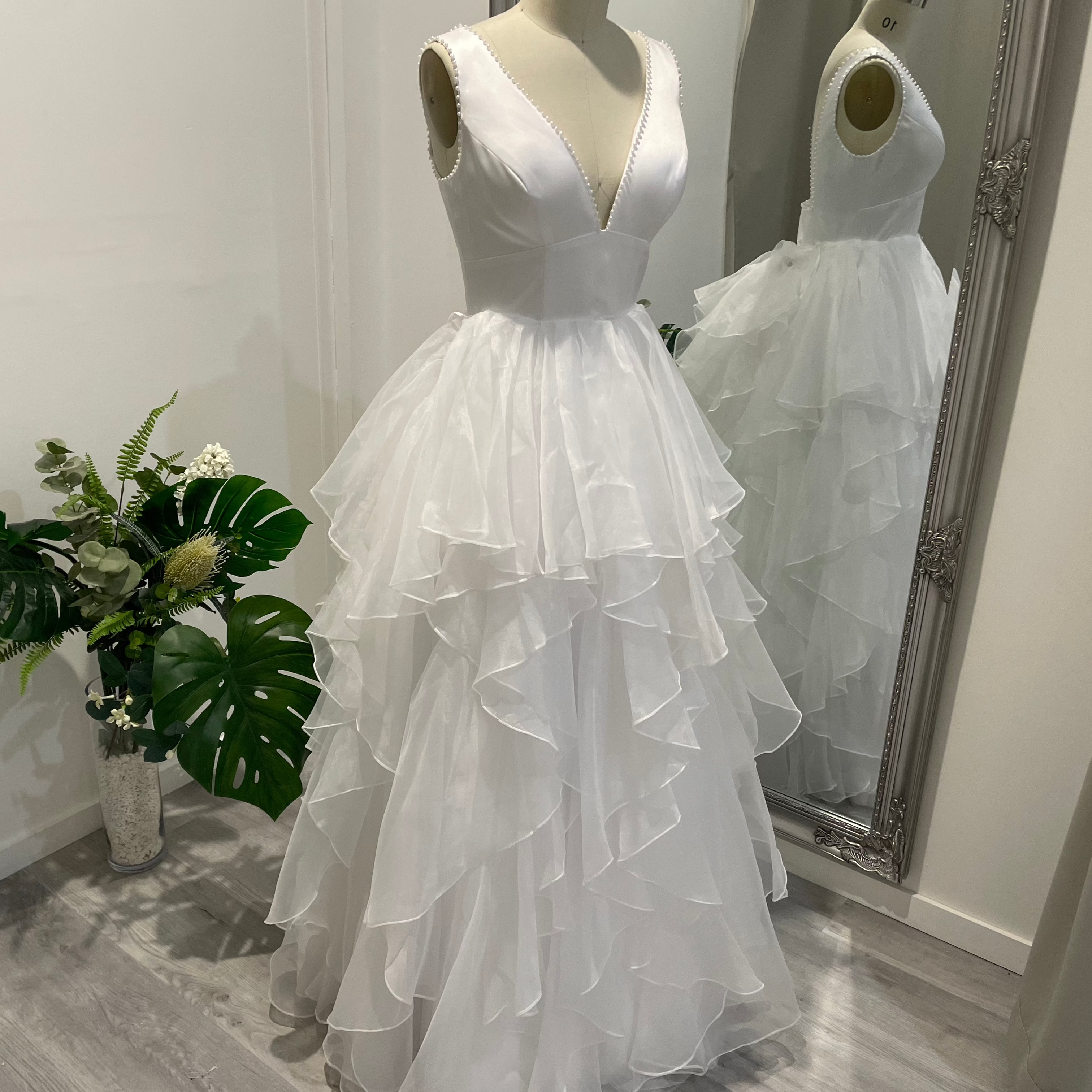 Liora Satin Whisper Deb Dress with pearl-trimmed V-neckline, satin A-line skirt, and slim straps