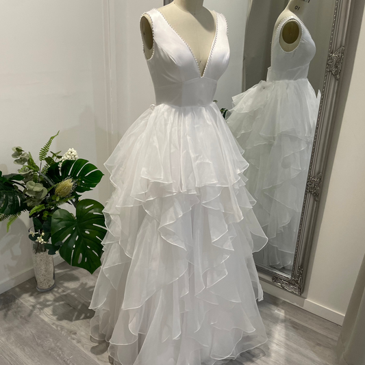 Liora Satin Whisper Deb Dress with pearl-trimmed V-neckline, satin A-line skirt, and slim straps