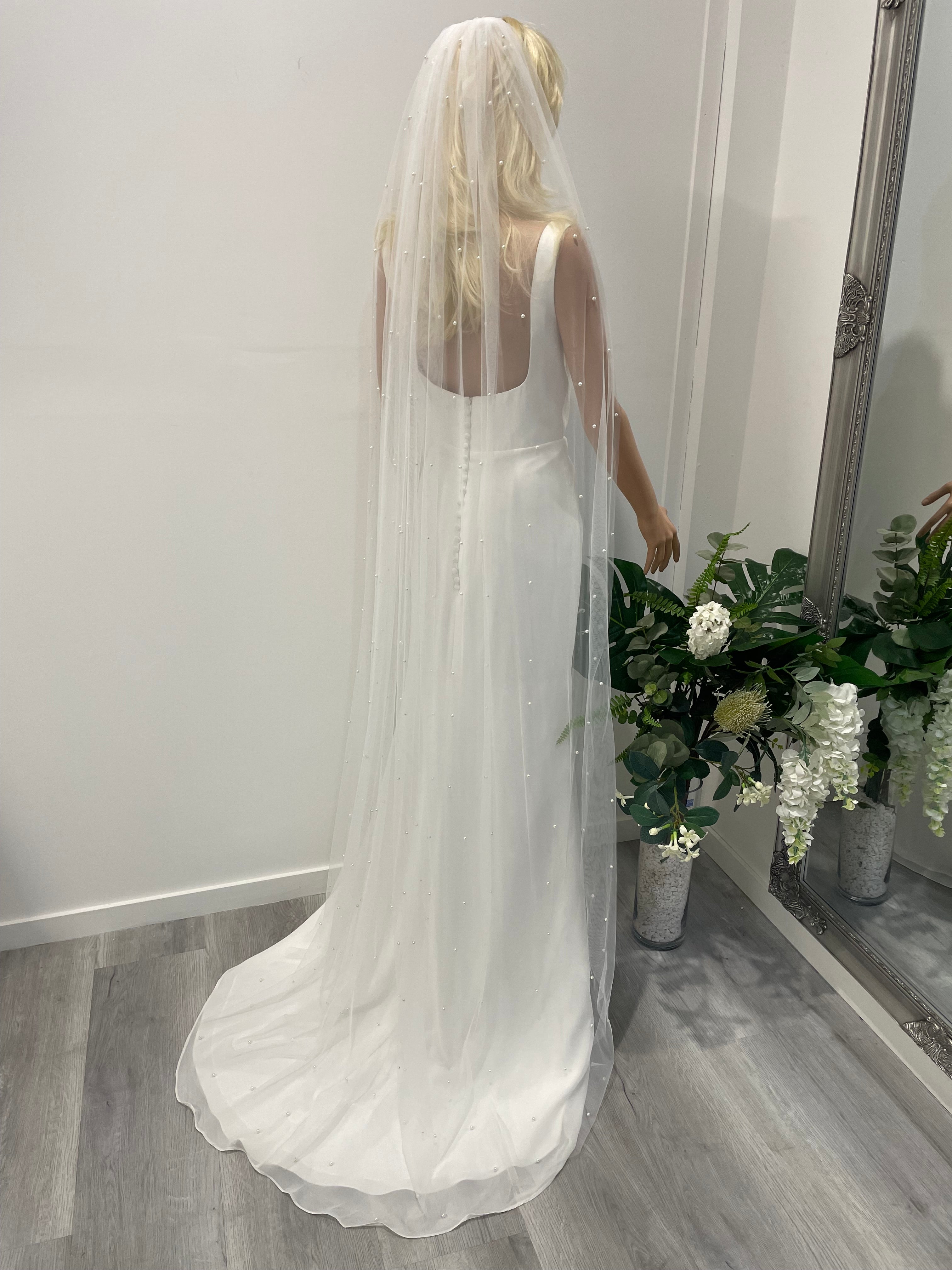 Side profile of bride wearing 2m long pearl bridal veil with scattered pearls