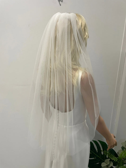 Back view of bride wearing 75cm plain soft tulle veil in light ivory