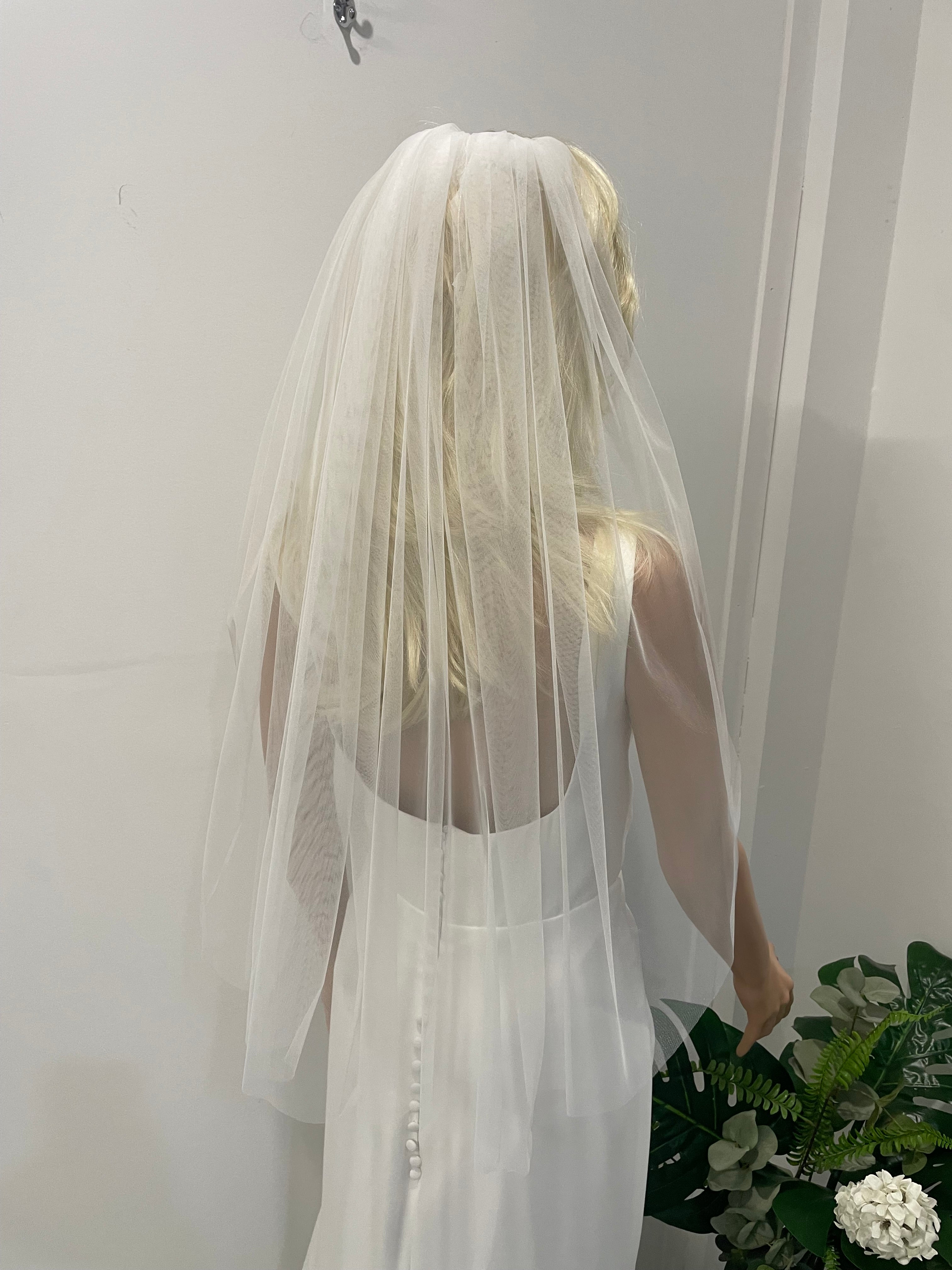 Back view of bride wearing 75cm plain soft tulle veil in light ivory