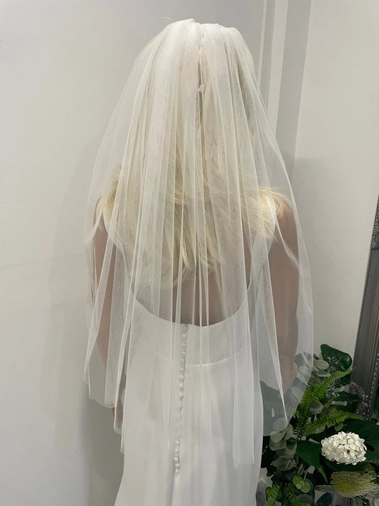 Back view of bride wearing 75cm plain soft tulle veil in light ivory