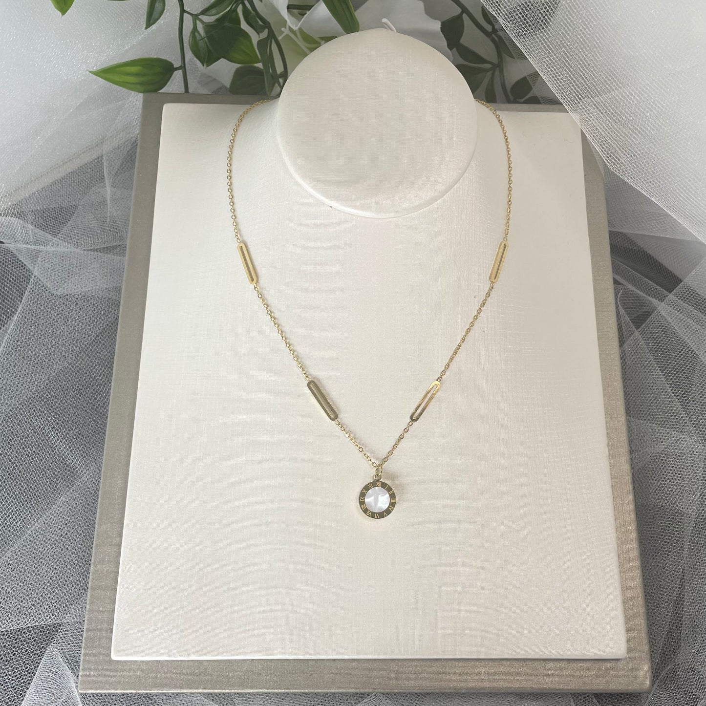 Adorn bridal necklace with reversible black & white Roman digital wafer pendant, gold accents, and stainless steel chain.