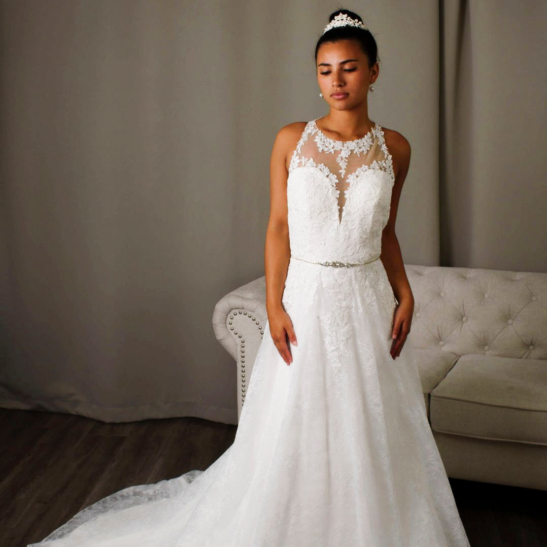 Bride wearing Fabiana A-line lace wedding dress with illusion neckline and diamanté belt detail.