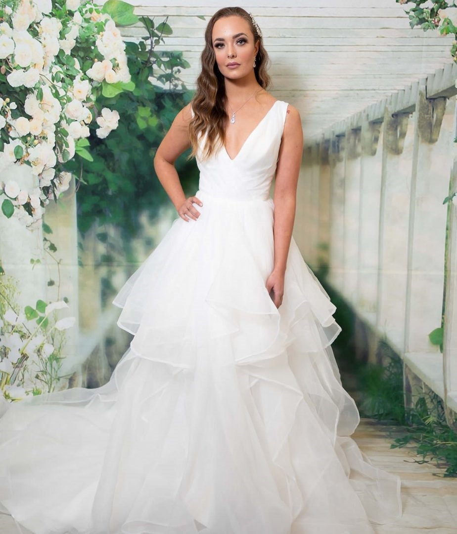 Gabriella bridal dress with a V-neckline and layered organza skirt.