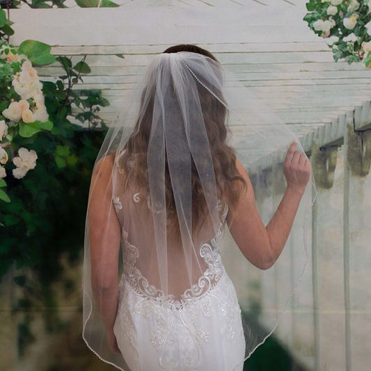 Shayla Beaded Trim Veil featuring petite diamanté edge detail, attached to a comb for easy wear, shown in ivory.