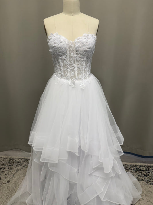 Abby V1 white sheer corset debutante dress, front view on mannequin with floral lace bodice and full ruffle skirt