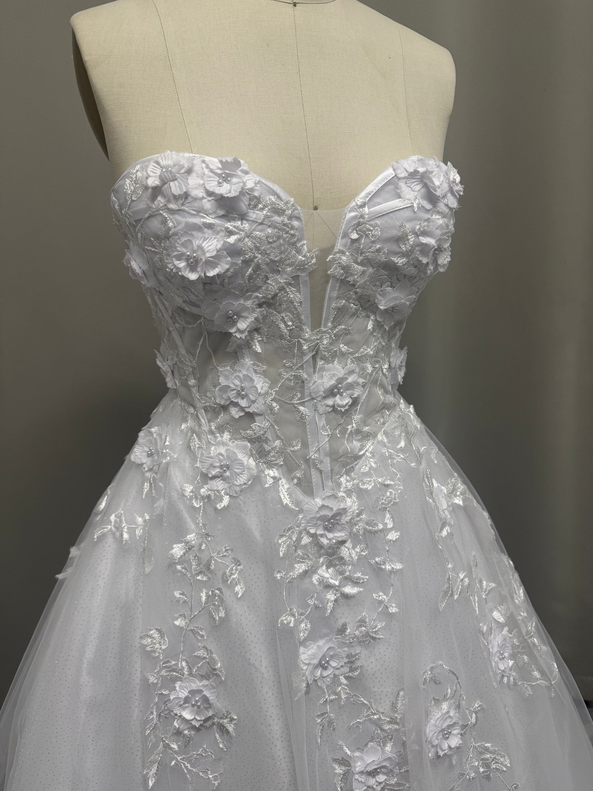 Close-up of Alana V1 3D floral debutante dress strapless sweetheart bodice with raised flowers and sheer corset panels