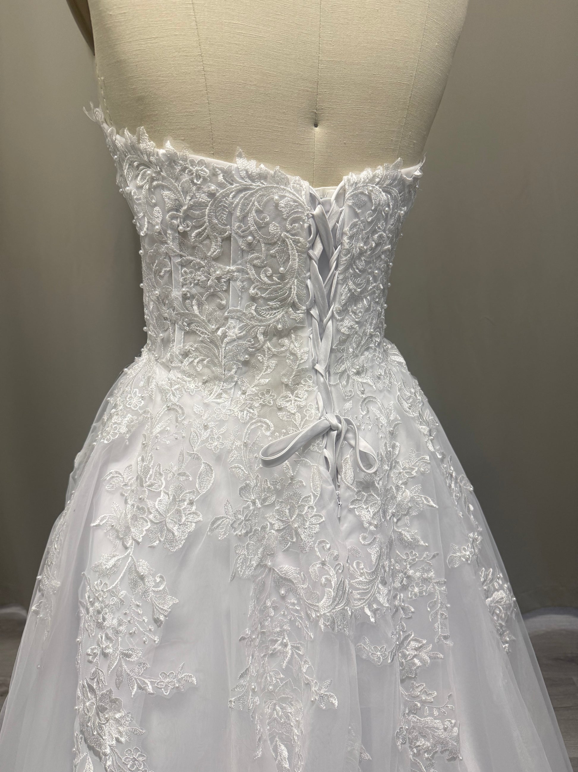 Alex deb ball dress back view showing lace-up corset, strapless lace bodice and full white tulle skirt