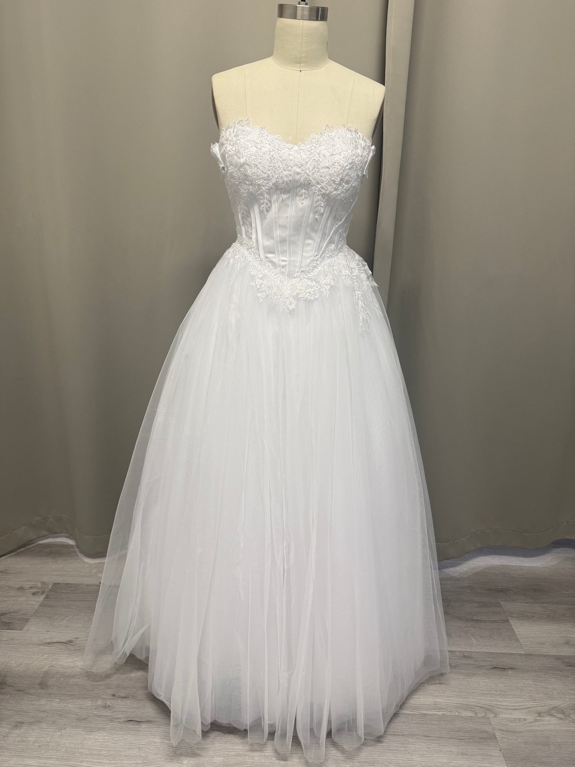 Alex deb ball dress front view showing lace-up corset, strapless lace bodice and full white tulle skirt