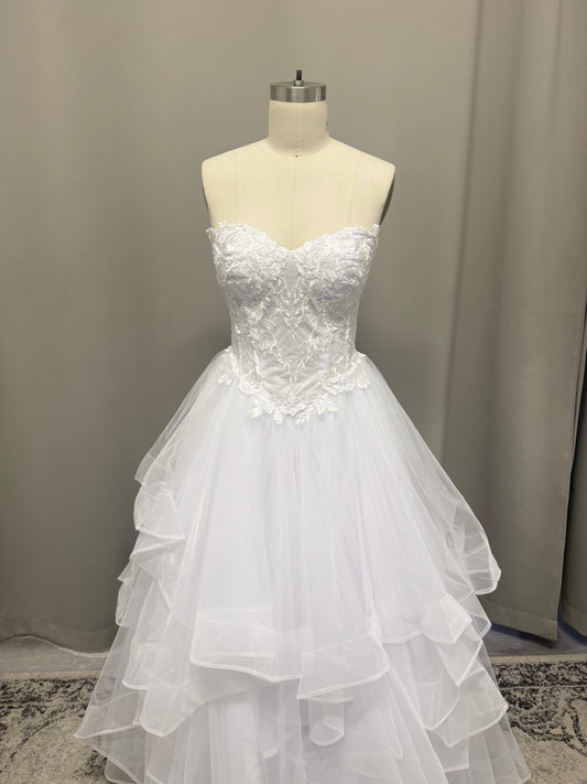 Amaira V1 white floral appliqué debutante dress, front view on mannequin with strapless lace corset and full ruffle skirt