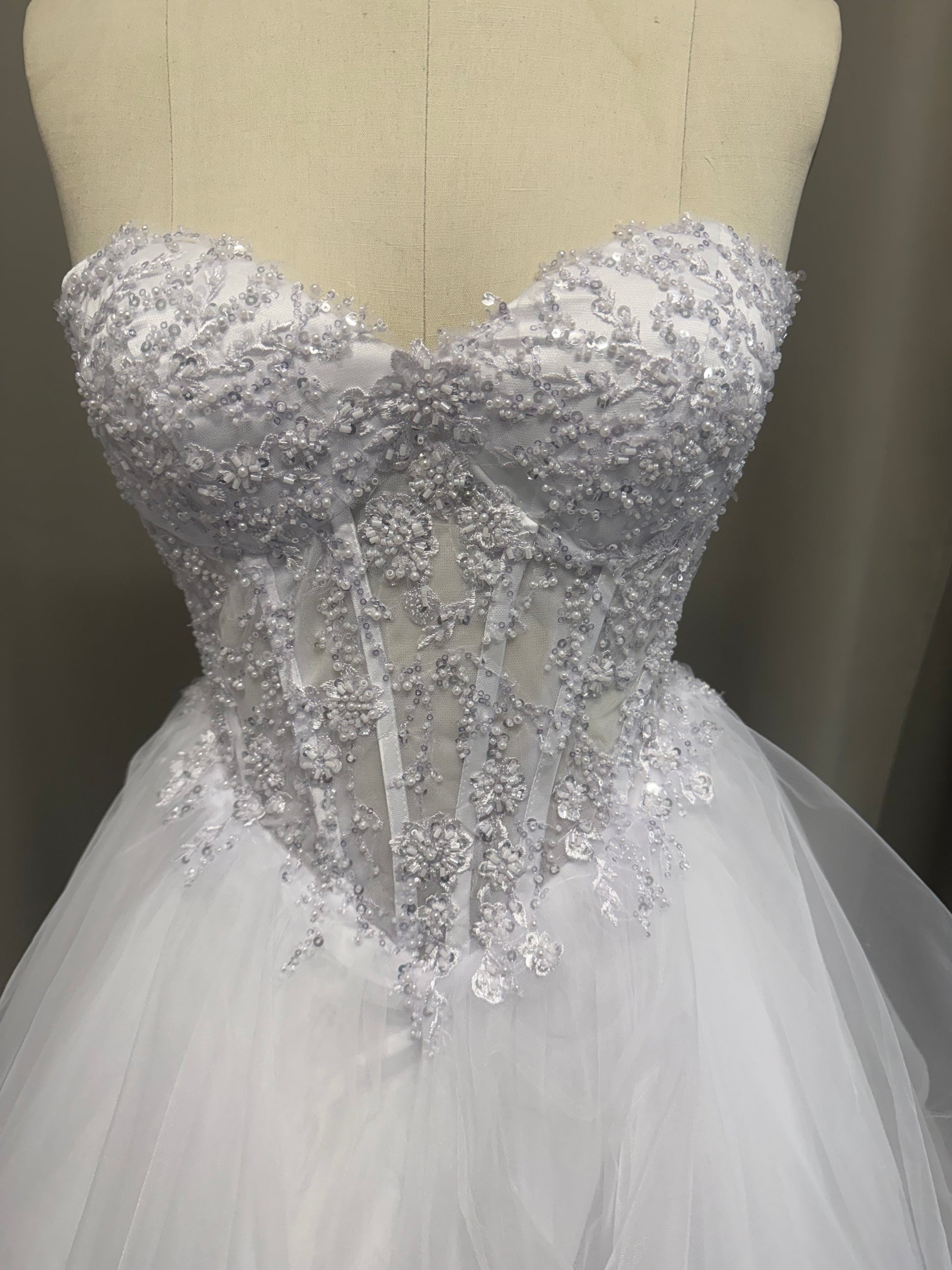 Close-up of Anvi V1 beaded debutante dress strapless sweetheart bodice with sequin, bead and pearl floral lace