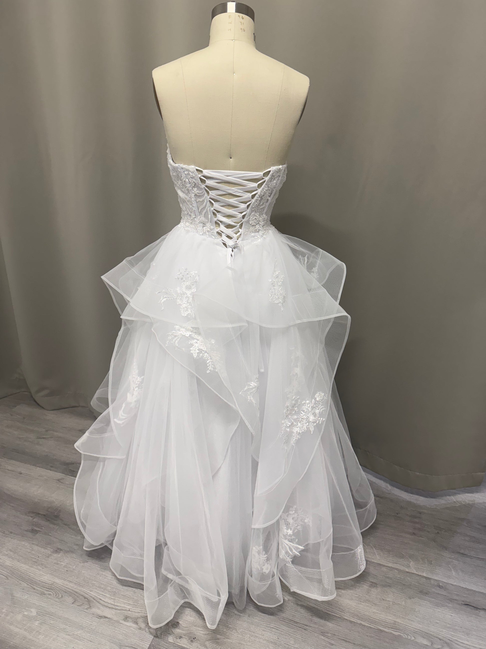 April Floral Lace Ruffled Strapless Debutante Ball Gown back view showing lace-up corset and ruffled tulle skirt with lace details