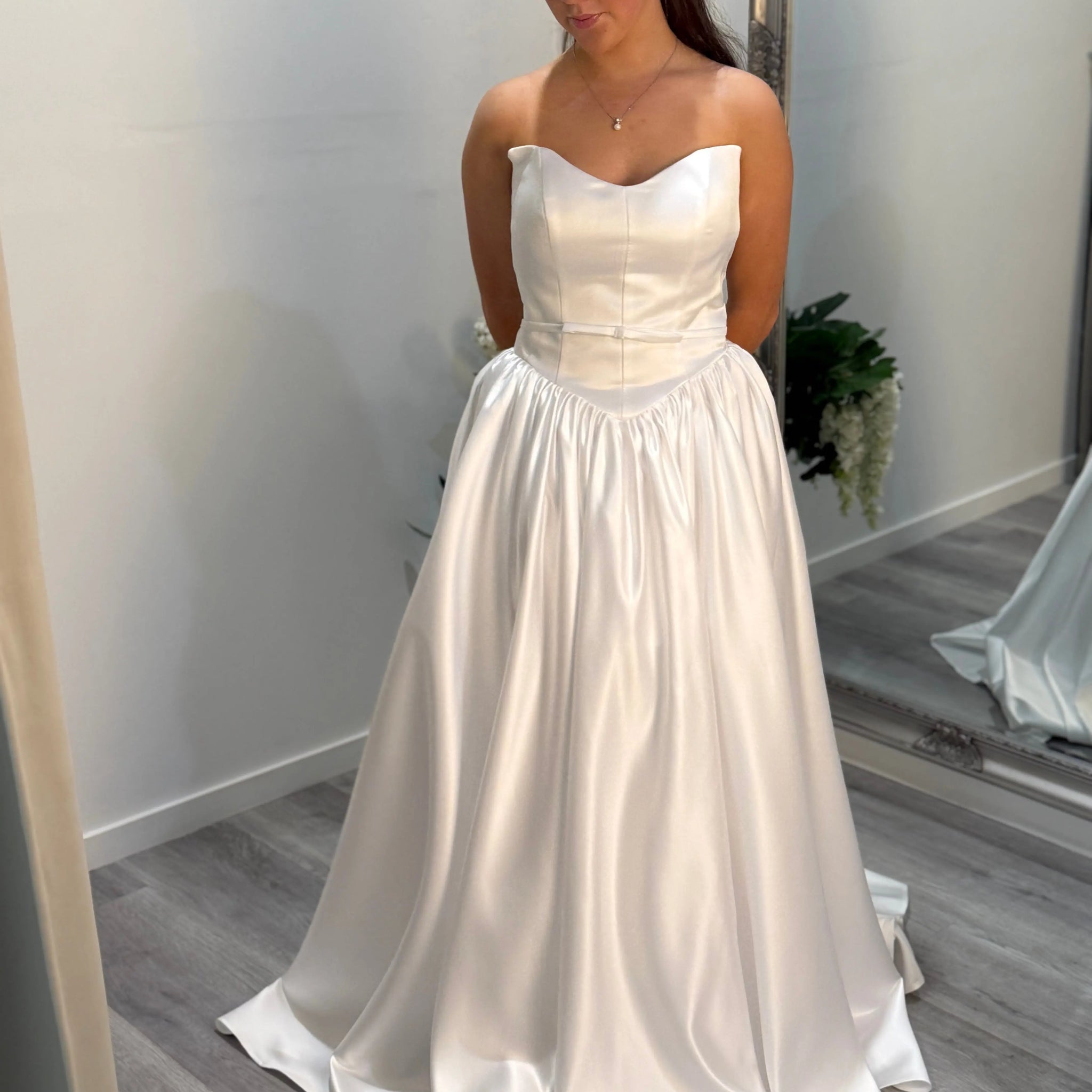Front of Billie debutante dress, model looking toward the ground