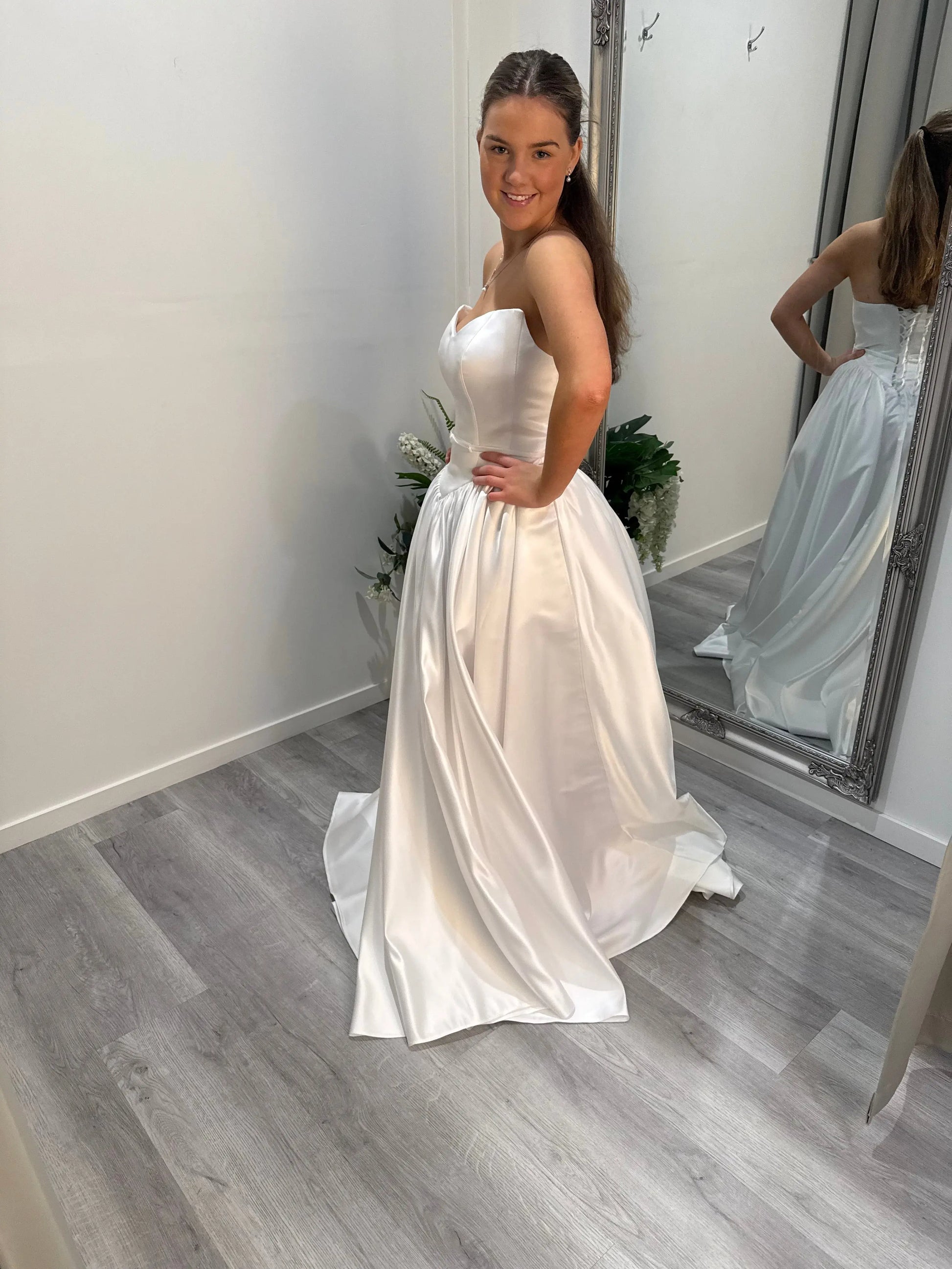 Side profile of Billie debut dress, model smiling at camera