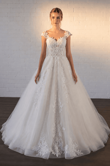 White lace A-line wedding dress with cap sleeves and a full tulle skirt.