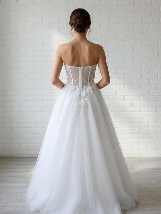 Elegant white strapless debutante dress with boned corset bodice, floral lace waist appliqués, and tulle skirt.