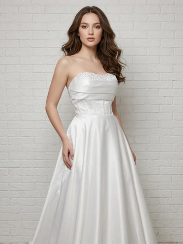Elegant white strapless satin debutante dress with sequined bodice and full flowing skirt.