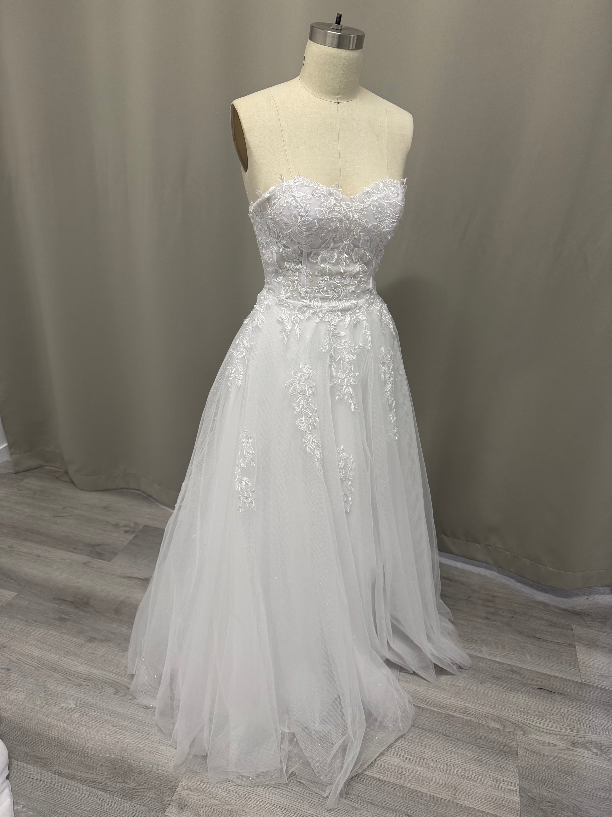 Coco Floral Lace Strapless Debutante Ball Gown on mannequin - elegant lace bodice with full tulle skirt