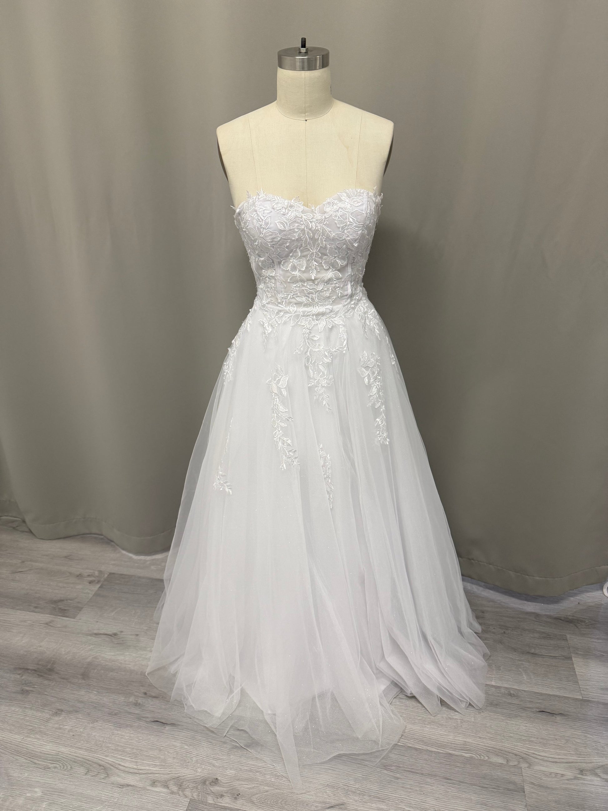 Coco Floral Lace Strapless Debutante Ball Gown on mannequin - elegant lace bodice with full tulle skirt
