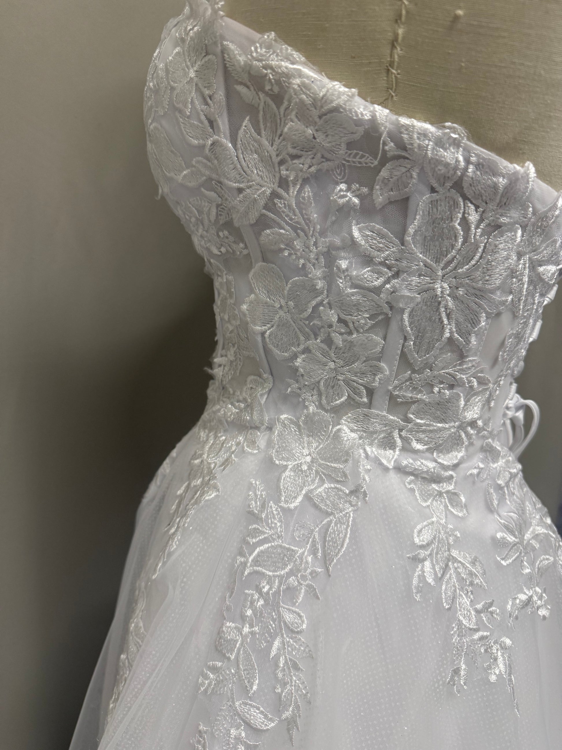 Close-up of Coco Debutante Ball Gown floral lace and corset side detailing