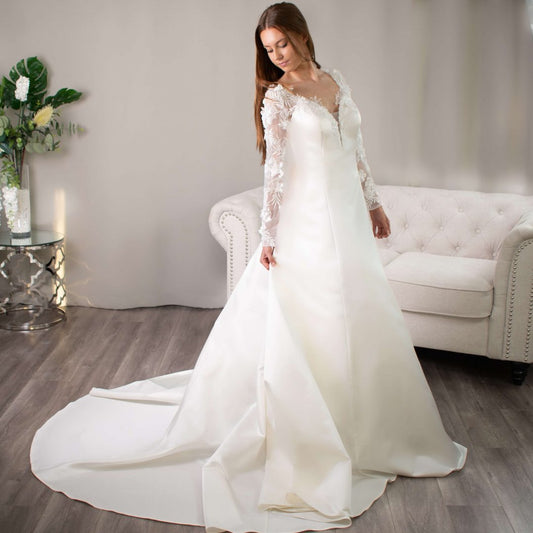 Bride in a Samantha 3D lace sleeve wedding dress with a long train.
