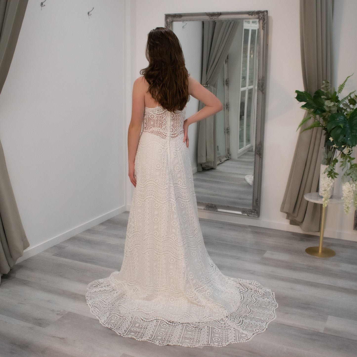 Bride adorned in Gwen Boho-inspired wedding gown, highlighting the wave lace design, sweetheart swirl neckline, and elegant train.