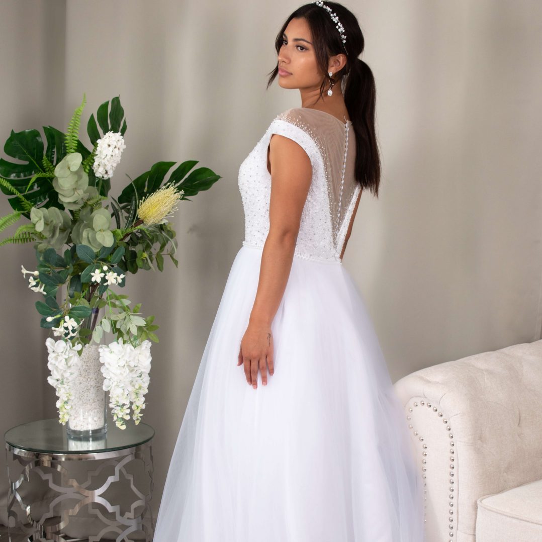 Magnolia Deb dress with a shimmering beaded bodice and flowing tulle skirt.
