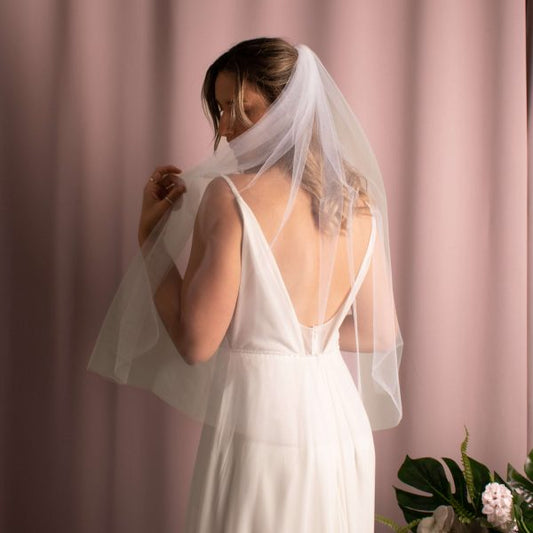 Sleek and simple Anita Veil in white, cascading elegantly down the back with a raw hand-cut edge, crafted from US tulle.
