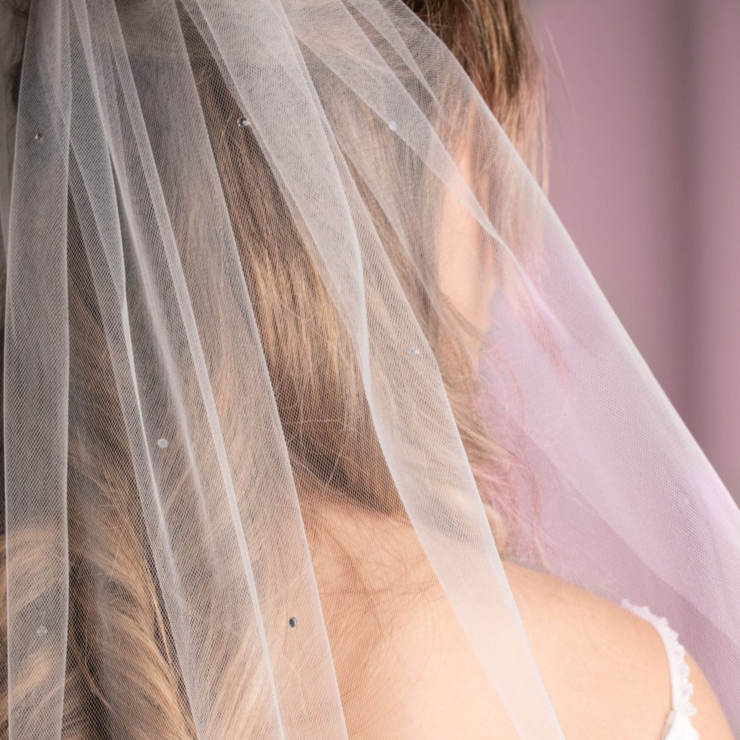 Cibrina Diamanté Wedding Veil displayed elegantly, highlighting the scattered diamantés on soft tulle.
