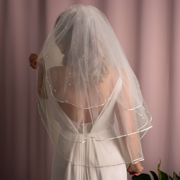Elara 3 Tier Pearl Veil with luxurious pearls and ribbon edge detailing on soft US tulle, creating a stunning bridal accessory.