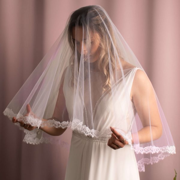Elliott Lace Trim Veil in fingertip length with lace edging, made of soft American tulle, draped elegantly over the face.