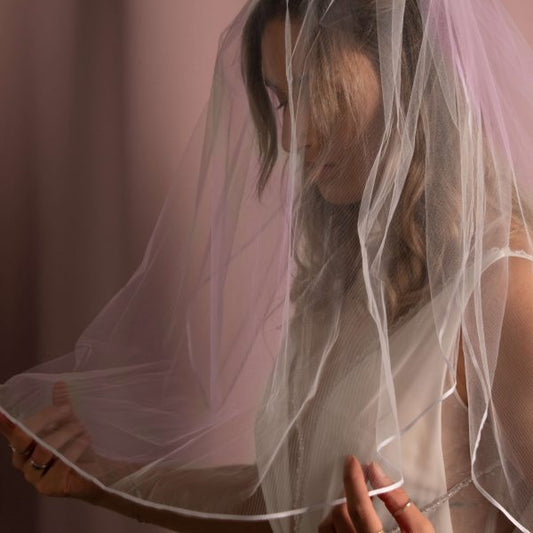 Bride in Zara Ribbon Edge Veil, showcasing its elegant two-tier design and delicate ribbon edging.